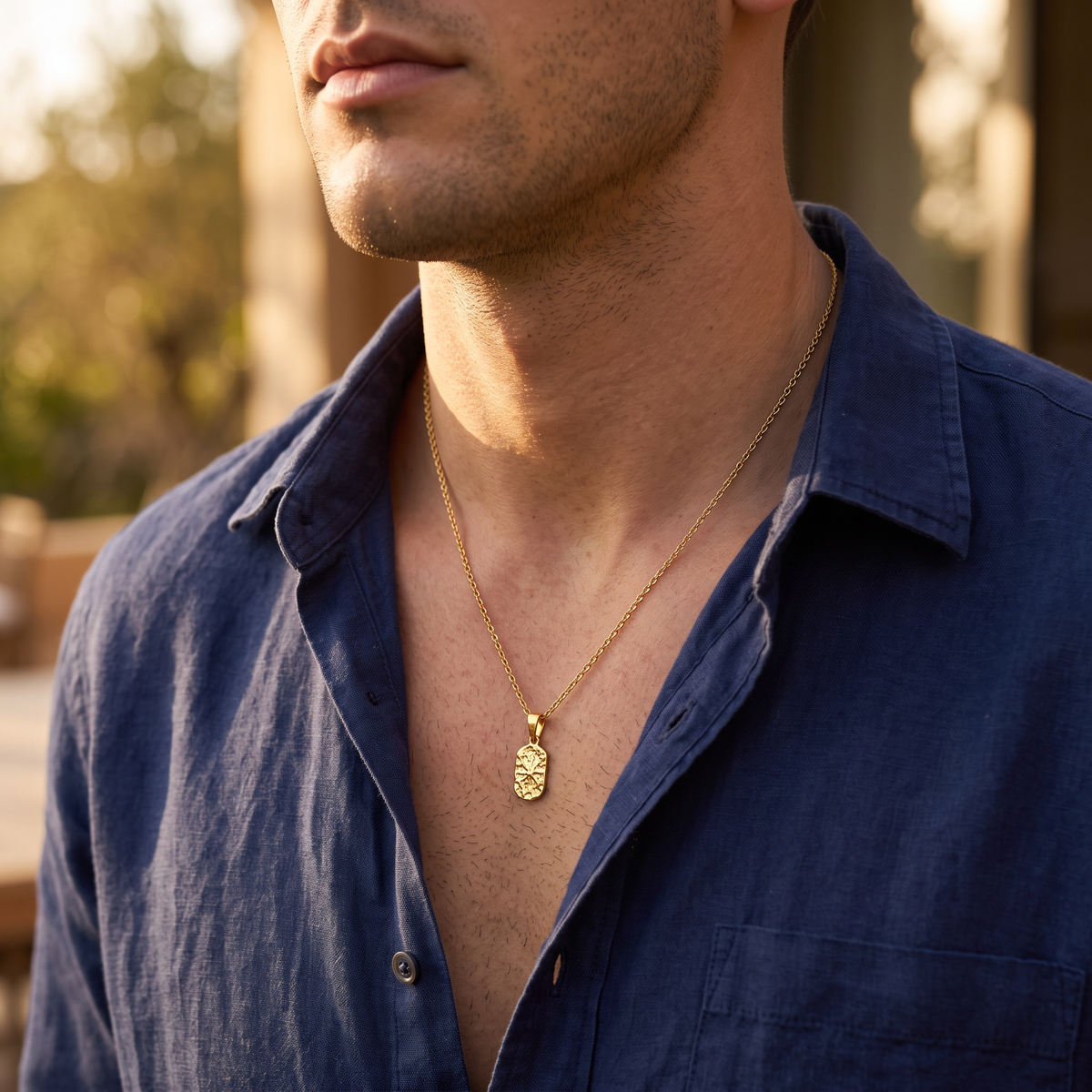 Man wearing El Norte hammered gold star tag necklace