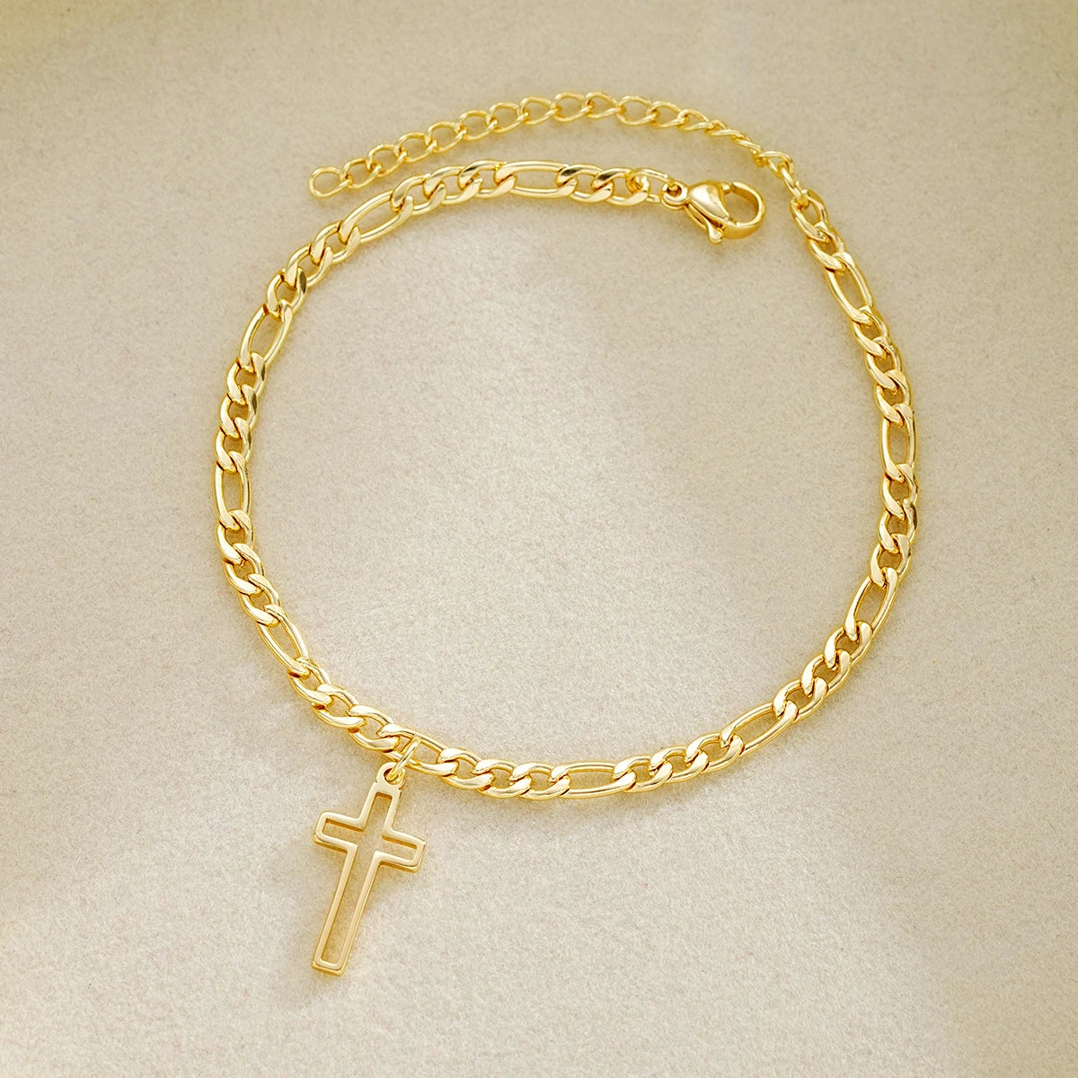 La Cruz gold-tone stainless steel cross bracelet laid flat
