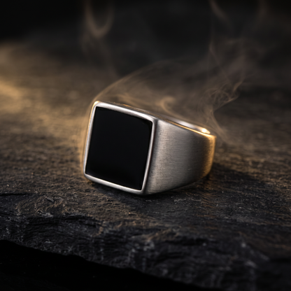 El Sello black square signet ring for men on dark slate, stainless steel