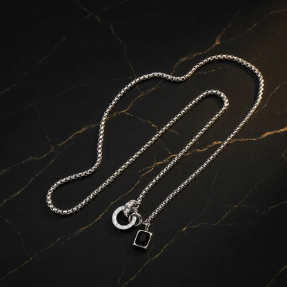 Full silver necklace on black marble with gold veining