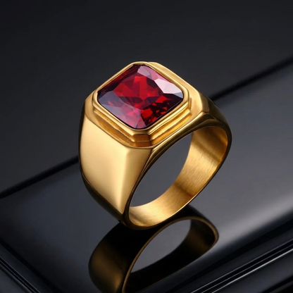 Yellow-gold red-stone ring on polished black metal